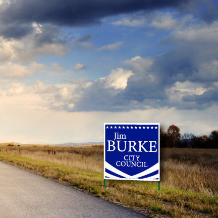A campaign yard sign on the side of a road